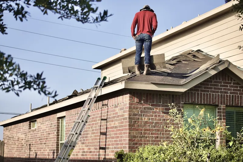 Professional roofer working on a residential roof in New Germany